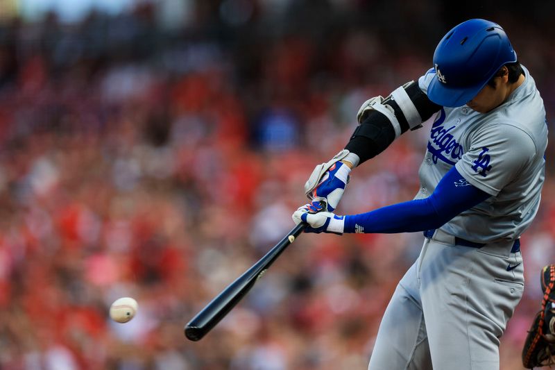 May 24, 2024; Cincinnati, Ohio, USA; Los Angeles Dodgers designated hitter Shohei Ohtani (17) hits a single against the Cincinnati Reds in the first inning at Great American Ball Park. Mandatory Credit: Katie Stratman-USA TODAY Sports