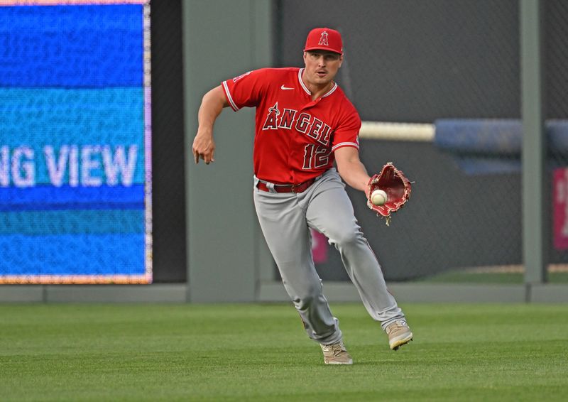 Jun 16, 2023; Kansas City, Missouri, USA; Los Angeles Angels right fielder Hunter Renfroe (12) fields the ball in the third inning against the Kansas City Royals at Kauffman Stadium. Mandatory Credit: Peter Aiken-USA TODAY Sports