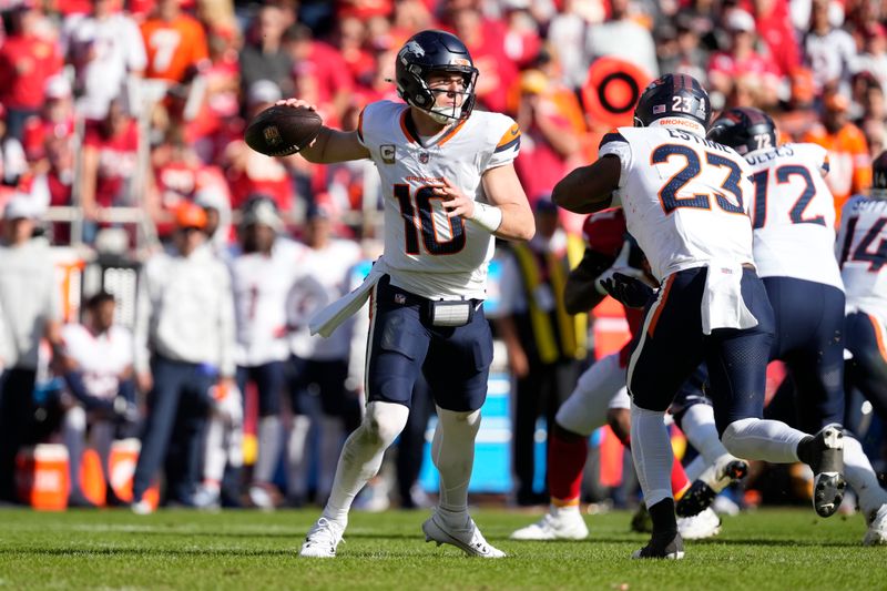 Denver Broncos quarterback Bo Nix throws during the first half of an NFL football game against the Kansas City Chiefs Sunday, Nov. 10, 2024, in Kansas City, Mo. (AP Photo/Ed Zurga)