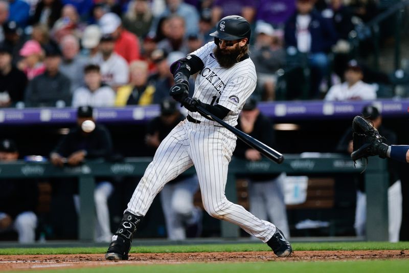 Aug 9, 2024; Denver, Colorado, USA; Colorado Rockies designated hitter Charlie Blackmon (19) hits an RBI single in the fourth inning against the Atlanta Braves at Coors Field. Mandatory Credit: Isaiah J. Downing-USA TODAY Sports