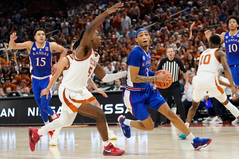 Mar 4, 2023; Austin, Texas, USA; Kansas Jayhawks guard Dajuan Harris Jr. (3) drives to the basket against Texas Longhorns guard Marcus Carr (5) during the second half at Moody Center. Mandatory Credit: Scott Wachter-USA TODAY Sports