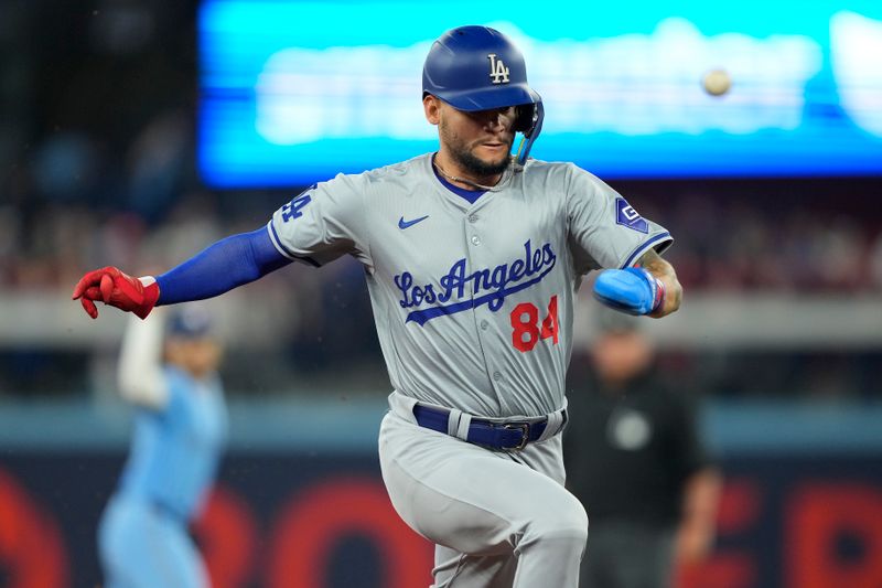 Apr 28, 2024; Toronto, Ontario, CAN; Los Angeles Dodgers right fielder Andy Pages (84) tries to steal third base against the Toronto Blue Jays during the second inning at Rogers Centre. Mandatory Credit: John E. Sokolowski-USA TODAY Sports