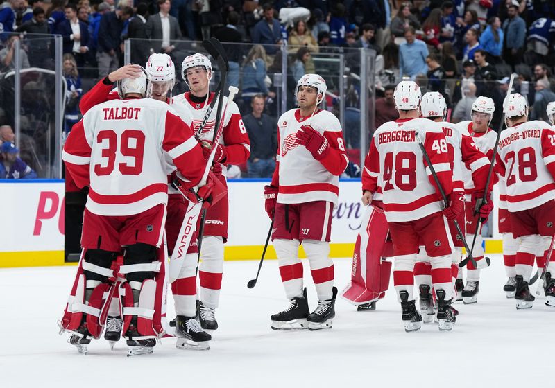 Oct 2, 2025; Toronto, Ontario, CAN; Detroit Red Wings defenseman Simon Edvinsson (77) celebrates the win with goaltender Cam Talbot (39) against the Toronto Maple Leafs at the end of the third period at Scotiabank Arena. Mandatory Credit: Nick Turchiaro-Imagn Images