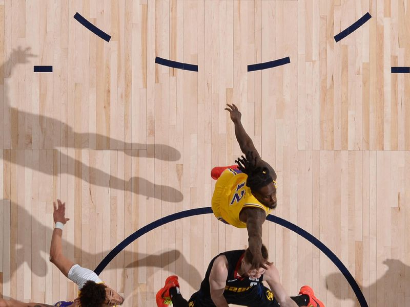 DENVER, CO - APRIL 22: Christian Braun #0 of the Denver Nuggets drives to the basket during the game against the Los Angeles Lakers on April 22, 2024 at the Ball Arena in Denver, Colorado. NOTE TO USER: User expressly acknowledges and agrees that, by downloading and/or using this Photograph, user is consenting to the terms and conditions of the Getty Images License Agreement. Mandatory Copyright Notice: Copyright 2024 NBAE (Photo by Bart Young/NBAE via Getty Images)