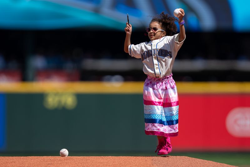 Jul 23, 2025; Seattle, Washington, USA;  A young fan dances on the pitcher's mound while waiting for the Seattle Mariners to take the field before a game Milwaukee Brewers at T-Mobile Park. Mandatory Credit: Stephen Brashear-Imagn Images