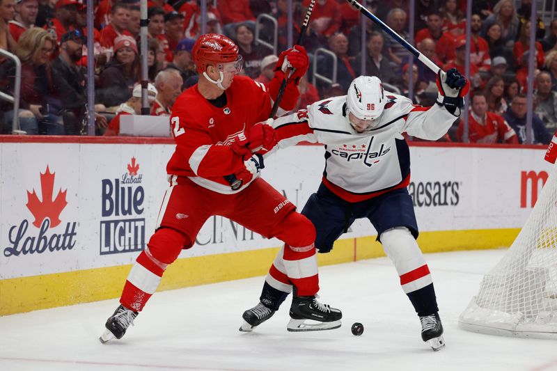 Apr 9, 2024; Detroit, Michigan, USA;  Detroit Red Wings defenseman Olli Maatta (2) and Washington Capitals right wing Nicolas Aube-Kubel (96)ref10 battle for the puck in the second period at Little Caesars Arena. Mandatory Credit: Rick Osentoski-USA TODAY Sports