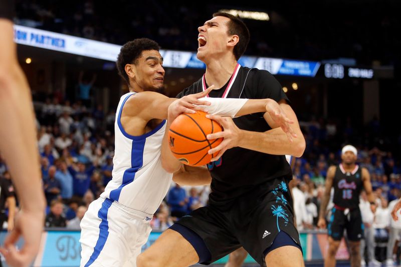 Feb 25, 2024; Memphis, Tennessee, USA; Florida Atlantic Owls center Vladislav Goldin (50) drives to the basket as Memphis Tigers forward Nicholas Jourdain (2) defends during the second half at FedExForum. Mandatory Credit: Petre Thomas-USA TODAY Sports