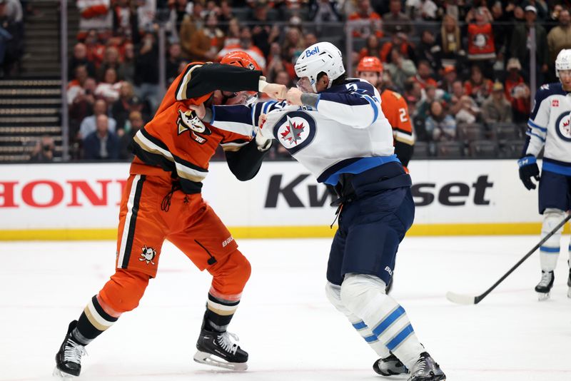 Feb 27, 2026; Anaheim, California, USA;  Anaheim Ducks left wing Ross Johnston (44) and Winnipeg Jets defenseman Luke Schenn (5) fight in the first period at Honda Center. Mandatory Credit: Kiyoshi Mio-Imagn Images