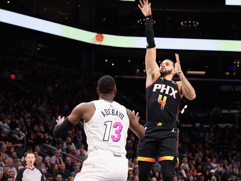 PHOENIX, ARIZONA - JANUARY 06: Duane Washington Jr. #4 of the Phoenix Suns puts up a shot over Bam Adebayo #13 of the Miami Heat during the second half of the NBA game at Footprint Center on January 06, 2023 in Phoenix, Arizona. The Heat defeated the Suns 104-96. NOTE TO USER: User expressly acknowledges and agrees that, by downloading and or using this photograph, User is consenting to the terms and conditions of the Getty Images License Agreement. (Photo by Christian Petersen/Getty Images)