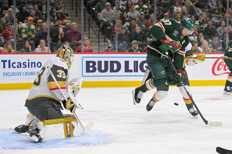 May 1, 2025; Saint Paul, Minnesota, USA;  Minnesota Wild forward Kirill Kaprizov (97) jumps as he deflects a puck towards Vegas Golden Knights goalie Adin Hill (33) during the second period in game six of the first round of the 2025 Stanley Cup Playoffs at Xcel Energy Center. Mandatory Credit: Nick Wosika-Imagn Images