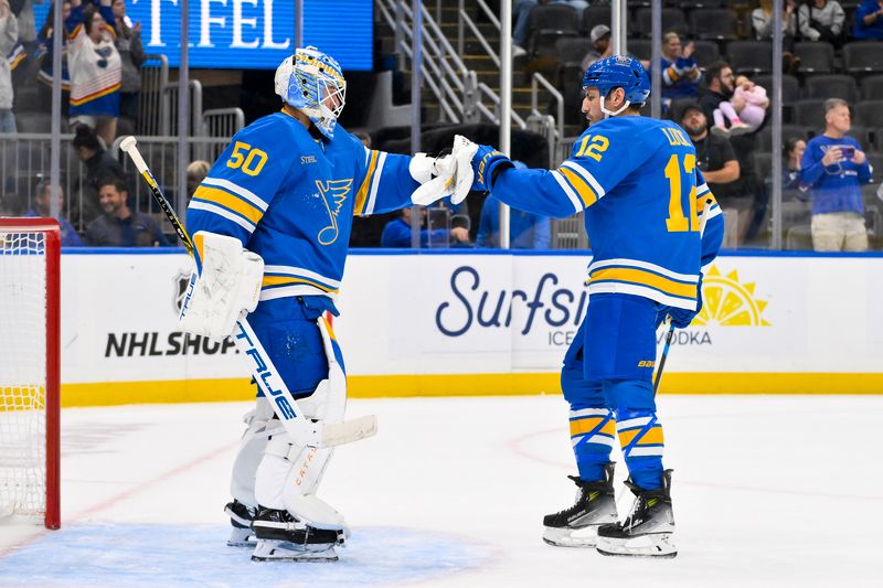Oct 2, 2025; St. Louis, Missouri, USA; St. Louis Blues goaltender Jordan Binnington (50) celebrates with left wing Milan Lucic (12) after the Blues defeated the Ottawa Senators at Enterprise Center. Mandatory Credit: Jeff Curry-Imagn Images