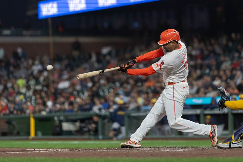 Sep 10, 2024; San Francisco, California, USA;  San Francisco Giants first base LaMonte Wade Jr. (31) hits a single during the fourth inning against the Milwaukee Brewers at Oracle Park. Mandatory Credit: Stan Szeto-Imagn Images