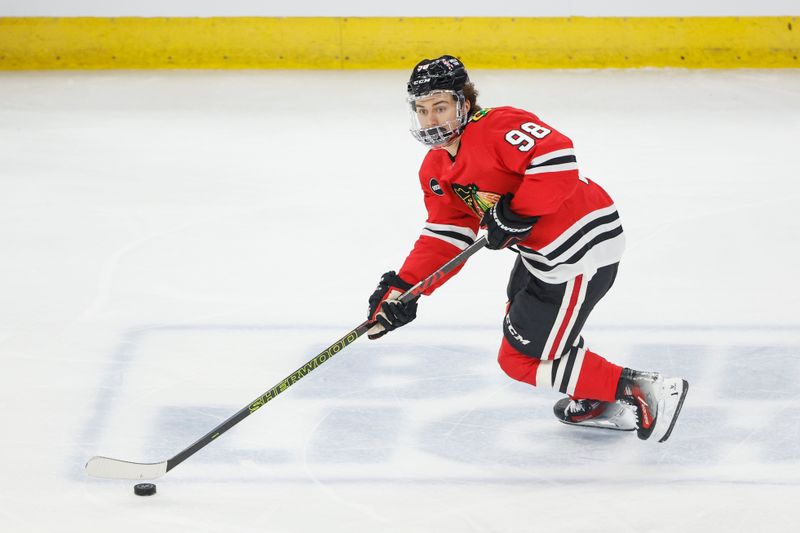 Feb 25, 2024; Chicago, Illinois, USA; Chicago Blackhawks center Connor Bedard (98) controls the puck against the Detroit Red Wings during the first period at United Center. Mandatory Credit: Kamil Krzaczynski-USA TODAY Sports