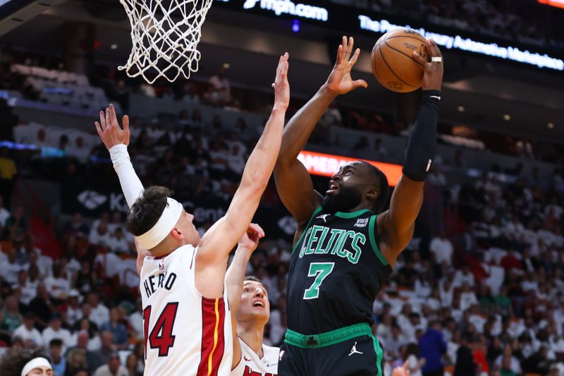 MIAMI, FLORIDA - APRIL 27: Jaylen Brown #7 of the Boston Celtics drives to the basket against Tyler Herro #14 of the Miami Heat during the first quarter in game three of the Eastern Conference First Round Playoffs at Kaseya Center on April 27, 2024 in Miami, Florida.  NOTE TO USER: User expressly acknowledges and agrees that, by downloading and or using this photograph, User is consenting to the terms and conditions of the Getty Images License Agreement. (Photo by Megan Briggs/Getty Images)