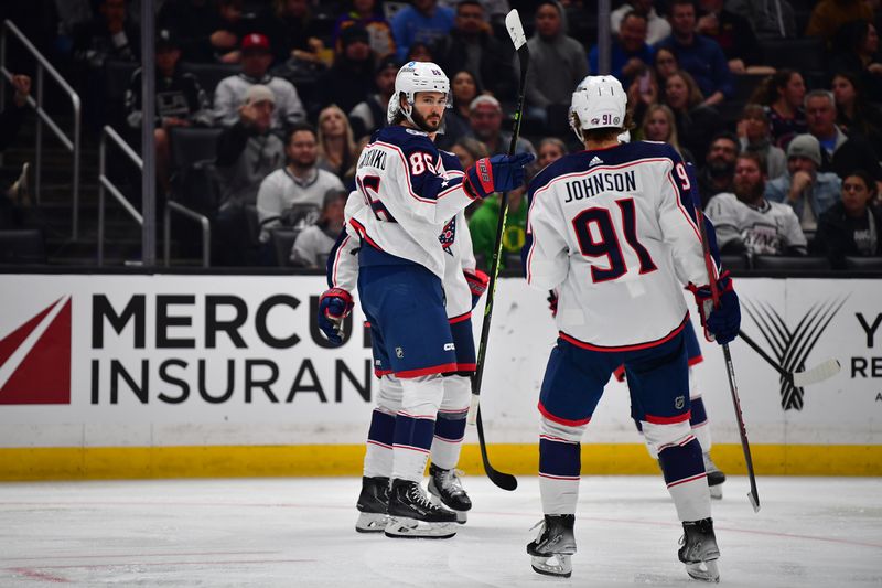 Mar 16, 2023; Los Angeles, California, USA; Columbus Blue Jackets right wing Kirill Marchenko (86) celebrates his goal scored against the Los Angeles Kings with center Kent Johnson (91) during the third period at Crypto.com Arena. Mandatory Credit: Gary A. Vasquez-USA TODAY Sports