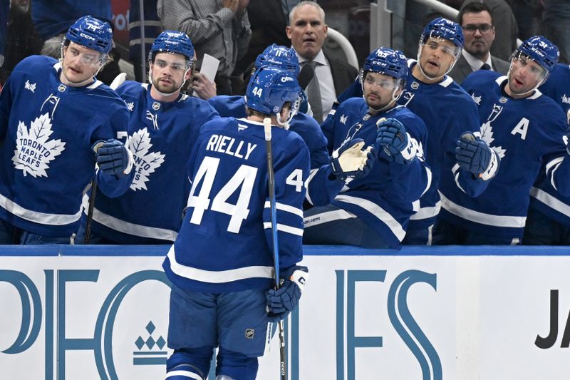 Feb 28, 2026; Toronto, Ontario, CAN;  Toronto Maple Leafs defenseman Morgan Rielly (44) celebrates with team mates at the bench after scoring a goal against the Ottawa Senators in the first period at Scotiabank Arena. Mandatory Credit: Dan Hamilton-Imagn Images