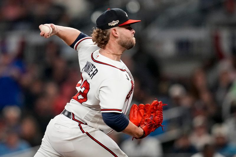 Oct 12, 2022; Atlanta, Georgia, USA; Atlanta Braves relief pitcher A.J. Minter (33) throws against the Philadelphia Phillies in the seventh inning during game two of the NLDS for the 2022 MLB Playoffs at Truist Park. Mandatory Credit: Dale Zanine-USA TODAY Sports