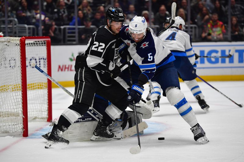 Dec 13, 2023; Los Angeles, California, USA; Winnipeg Jets defenseman Brenden Dillon (5) helps defend the goal against Los Angeles Kings left wing Kevin Fiala (22) during the second period at Crypto.com Arena. Mandatory Credit: Gary A. Vasquez-USA TODAY Sports