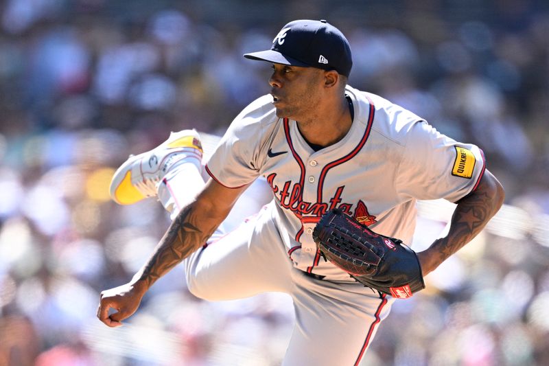 Jul 14, 2024; San Diego, California, USA; Atlanta Braves relief pitcher Raisel Iglesias (26) pitches against the San Diego Padres during the ninth inning at Petco Park. Mandatory Credit: Orlando Ramirez-USA TODAY Sports