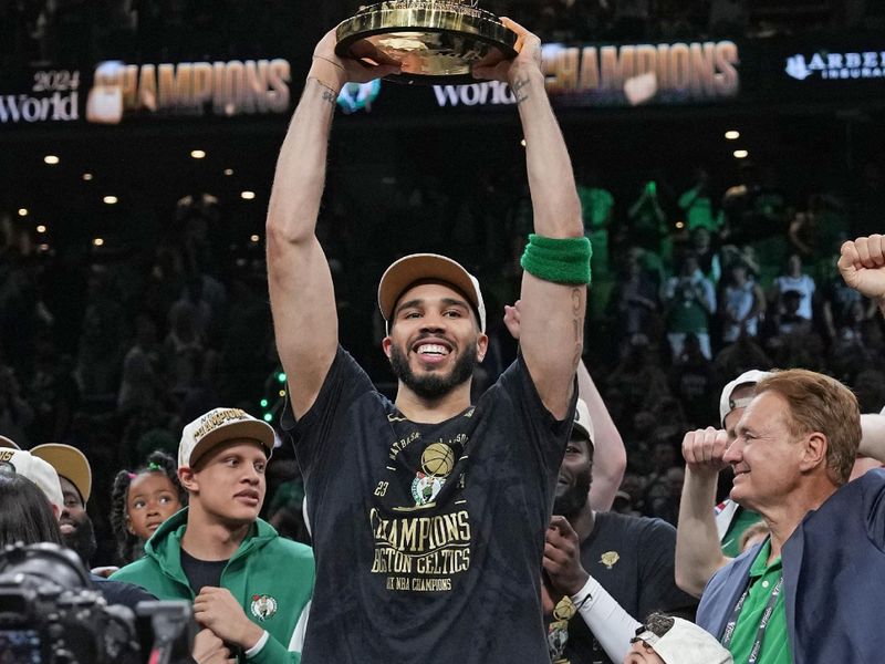 BOSTON, MA - JUNE 17: Jayson Tatum #0 of the Boston Celtics holds up the Larry O'Brien Trophy after the game against the Dallas Mavericks during Game 5 of the 2024 NBA Finals on June 17, 2024 at the TD Garden in Boston, Massachusetts. NOTE TO USER: User expressly acknowledges and agrees that, by downloading and or using this photograph, User is consenting to the terms and conditions of the Getty Images License Agreement. Mandatory Copyright Notice: Copyright 2024 NBAE  (Photo by Jesse D. Garrabrant/NBAE via Getty Images)