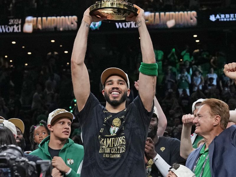 BOSTON, MA - JUNE 17: Jayson Tatum #0 of the Boston Celtics holds up the Larry O'Brien Trophy after the game against the Dallas Mavericks during Game 5 of the 2024 NBA Finals on June 17, 2024 at the TD Garden in Boston, Massachusetts. NOTE TO USER: User expressly acknowledges and agrees that, by downloading and or using this photograph, User is consenting to the terms and conditions of the Getty Images License Agreement. Mandatory Copyright Notice: Copyright 2024 NBAE  (Photo by Jesse D. Garrabrant/NBAE via Getty Images)