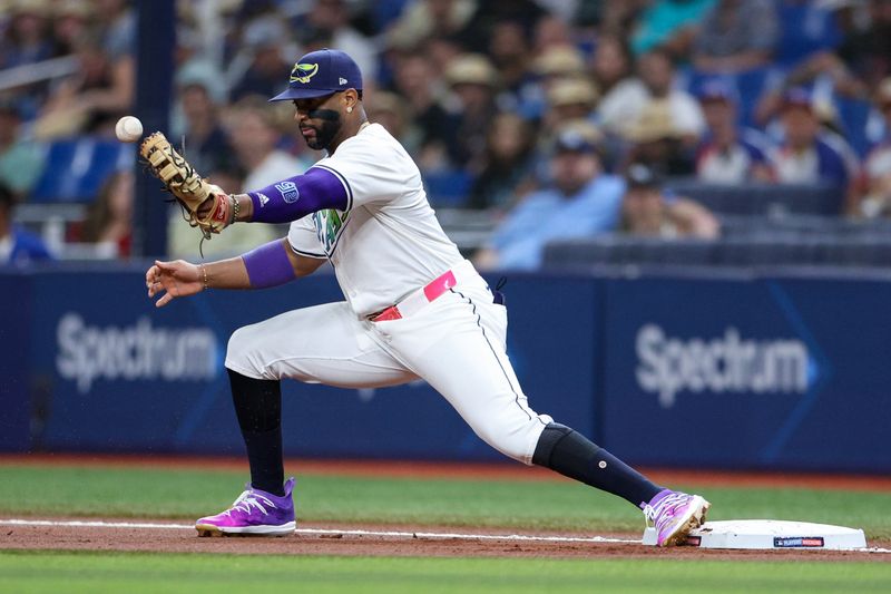 Aug 16, 2024; St. Petersburg, Florida, USA; Tampa Bay Rays first baseman Yandi Diaz (2) bobbles the ball against the Arizona Diamondbacks in the first inning at Tropicana Field. Mandatory Credit: Nathan Ray Seebeck-USA TODAY Sports