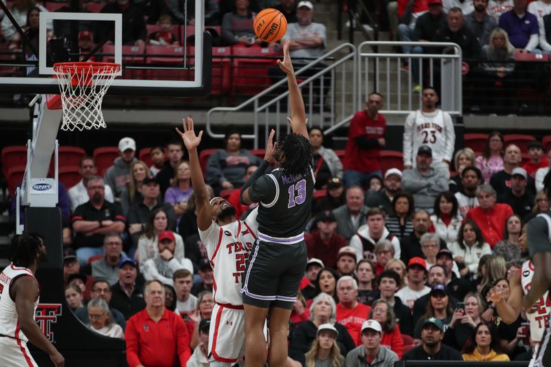 Jan 13, 2024; Lubbock, Texas, USA;  Kansas State Wildcats center Will McNair Jr. (13) shoots over Texas Tech Red Raiders forward Warren Washington (22) in the first half at United Supermarkets Arena. Mandatory Credit: Michael C. Johnson-USA TODAY Sports