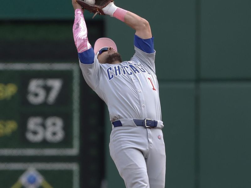 May 12, 2024; Pittsburgh, Pennsylvania, USA;  Chicago Cubs fist baseman Patrick Wisdom (16) catches a pop-up to retire Pittsburgh Pirates shortstop Oneil Cruz (not pictured) during the seventh inning at PNC Park. Mandatory Credit: Charles LeClaire-USA TODAY Sports