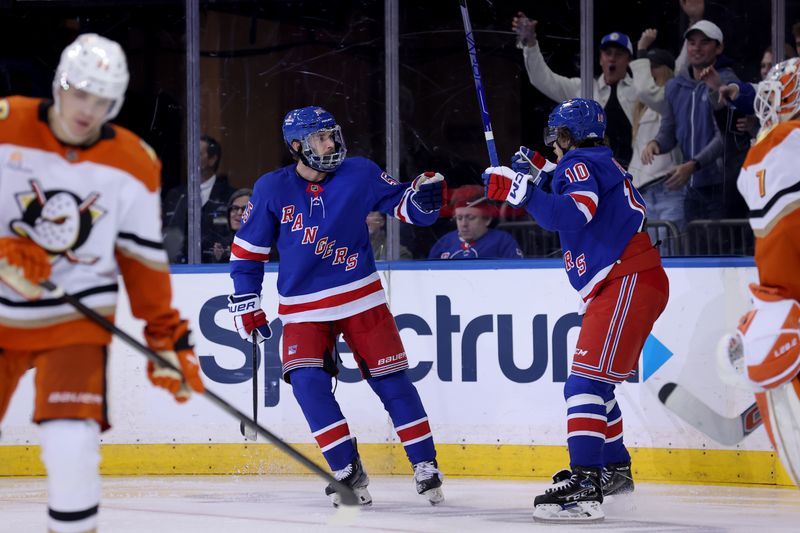 Oct 26, 2024; New York, New York, USA; New York Rangers defenseman Ryan Lindgren (55) celebrates his goal against the Anaheim Ducks with left wing Artemi Panarin (10) during the third period at Madison Square Garden. Mandatory Credit: Brad Penner-Imagn Images