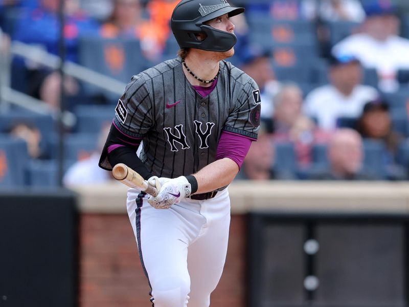 May 31, 2025; New York City, New York, USA; New York Mets third baseman Brett Baty (7) follows through on a three run triple against the Colorado Rockies during the first inning at Citi Field. Mandatory Credit: Brad Penner-Imagn Images