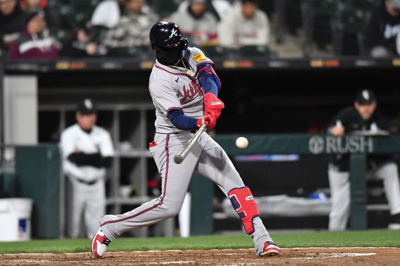 Apr 2, 2024; Chicago, Illinois, USA; Atlanta Braves shortstop Orlando Arcia (11) singles during the fifth inning against the Chicago White Sox at Guaranteed Rate Field. Mandatory Credit: Patrick Gorski-USA TODAY Sports
