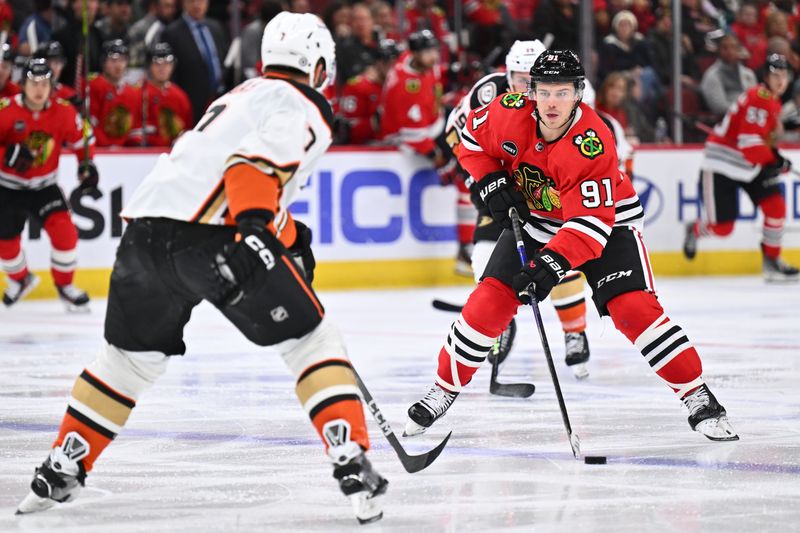 Dec 7, 2023; Chicago, Illinois, USA; Chicago Blackhawks forward Anthony Beauvillier (91) skates the puck up the ice in the third period against the Anaheim Ducks at United Center. Mandatory Credit: Jamie Sabau-USA TODAY Sports