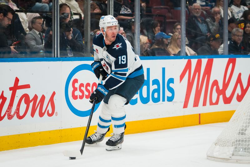 Nov 11, 2025; Vancouver, British Columbia, CAN; Winnipeg Jets forward Jonathan Toews (19) handles the puck against the Vancouver Canucks in the first period at Rogers Arena. Mandatory Credit: Bob Frid-Imagn Images