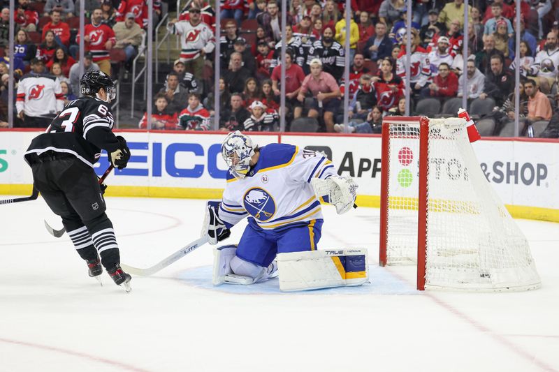 Oct 27, 2023; Newark, New Jersey, USA; New Jersey Devils left wing Jesper Bratt (63) scores a goal past Buffalo Sabres goaltender Eric Comrie (31) during the first period at Prudential Center. Mandatory Credit: Vincent Carchietta-USA TODAY Sports