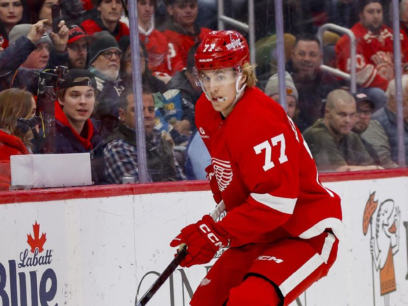 Mar 19, 2024; Detroit, Michigan, USA; Detroit Red Wings defenseman Simon Edvinsson (77) handles the during the first period of the game against the Columbus Blue Jackets at Little Caesars Arena. Mandatory Credit: Brian Bradshaw Sevald-USA TODAY Sports