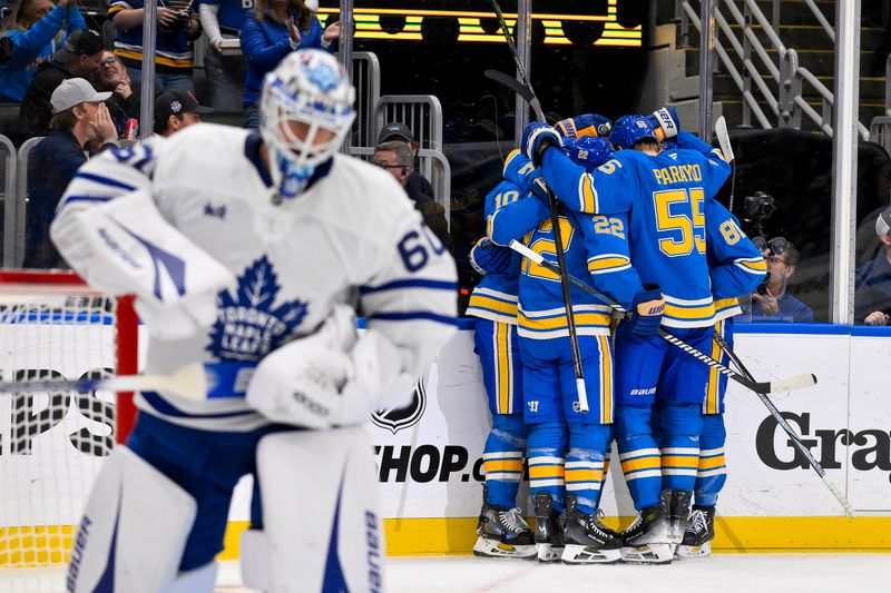 Nov 2, 2024; St. Louis, Missouri, USA;  St. Louis Blues center Jordan Kyrou (25) celebrates with center Brayden Schenn (10) center Dylan Holloway (81) and defenseman Ryan Suter (22) and defenseman Colton Parayko (55) after scoring against Toronto Maple Leafs goaltender Joseph Woll (60) during the second period at Enterprise Center. Mandatory Credit: Jeff Curry-Imagn Images