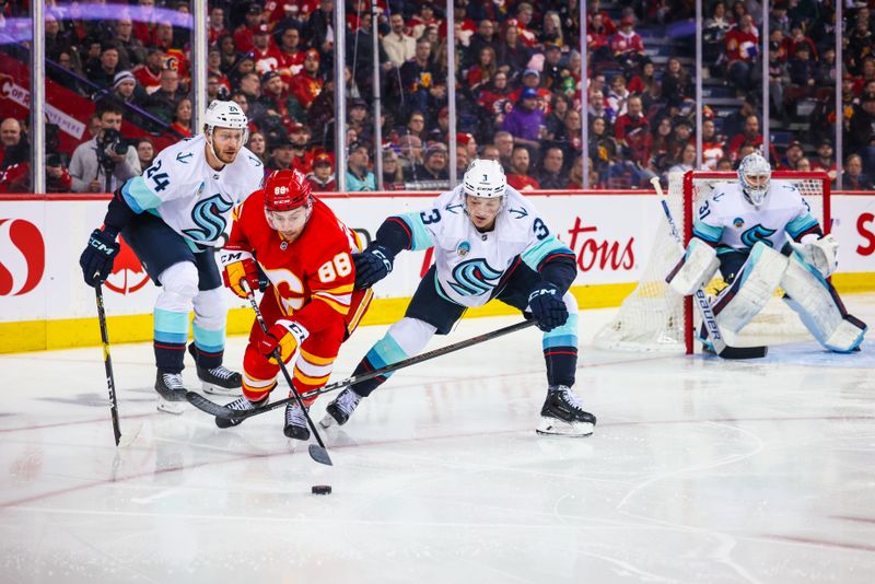 Mar 4, 2024; Calgary, Alberta, CAN; Calgary Flames left wing Andrew Mangiapane (88) and Seattle Kraken defenseman Will Borgen (3) battles for the puck during the second period at Scotiabank Saddledome. Mandatory Credit: Sergei Belski-USA TODAY Sports