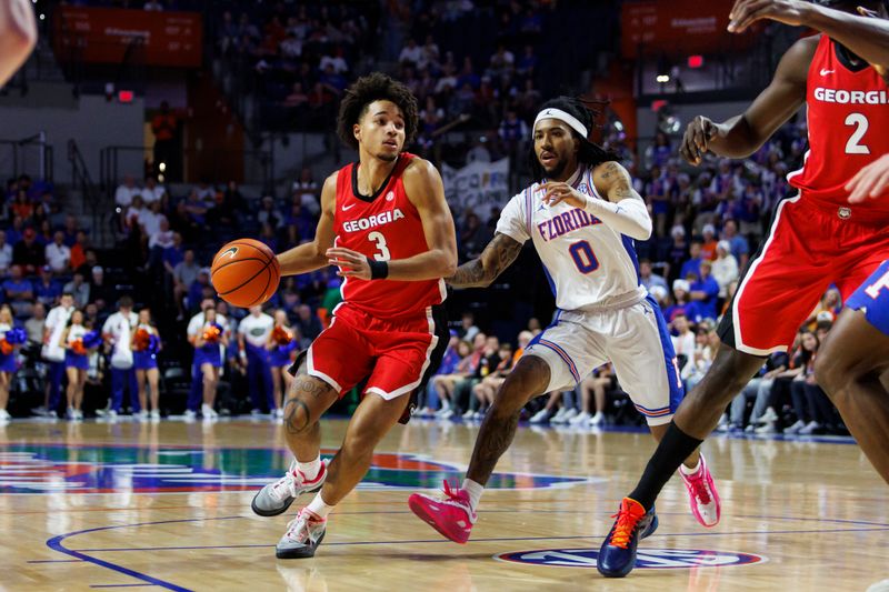 Jan 6, 2026; Gainesville, Florida, USA; Georgia Bulldogs guard Jordan Ross (3) dribbles the ball past Florida Gators guard Boogie Fland (0) during the first half at Exactech Arena at the Stephen C. O'Connell Center. Mandatory Credit: Morgan Tencza-Imagn Images