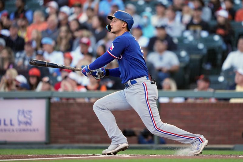 Aug 12, 2023; San Francisco, California, USA; Texas Rangers shortstop Corey Seager (5) hits a home run against the San Francisco Giants during the first inning at Oracle Park. Mandatory Credit: Darren Yamashita-USA TODAY Sports