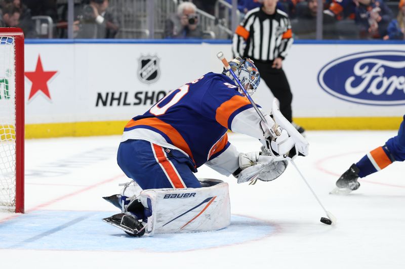 Jan 18, 2025; Elmont, New York, USA;  New York Islanders goaltender Marcus Hogberg (50) makes a stop against the San Jose Sharks during the third period at UBS Arena. Mandatory Credit: Thomas Salus-Imagn Images