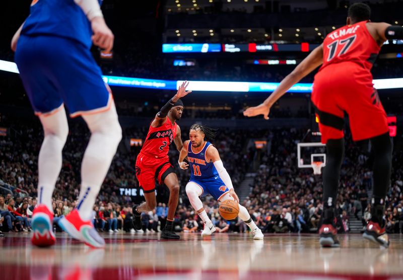 TORONTO, ON - MARCH 27: Jalen Brunson #11 of the New York Knicks drives against Jalen McDaniels #2 of the Toronto Raptors during the first half of their basketball game at the Scotiabank Arena on March 27, 2024 in Toronto, Ontario, Canada. NOTE TO USER: User expressly acknowledges and agrees that, by downloading and/or using this Photograph, user is consenting to the terms and conditions of the Getty Images License Agreement. (Photo by Mark Blinch/Getty Images)