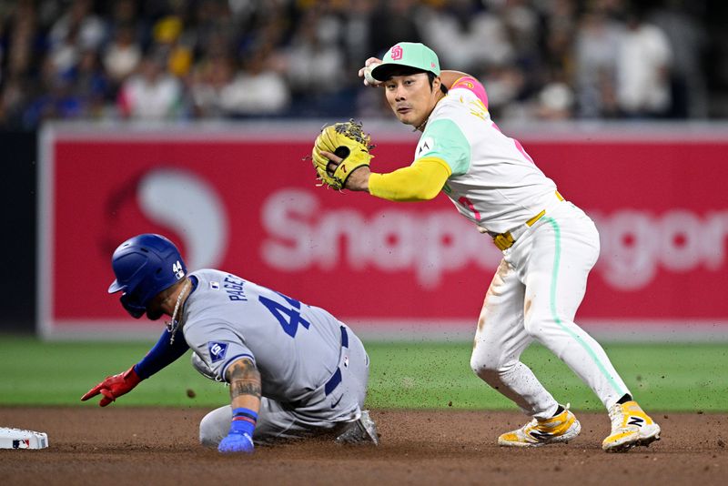 May 10, 2024; San Diego, California, USA; San Diego Padres shortstop Ha-Seong Kim (right) throws to first base late after forcing out Los Angeles Dodgers right fielder Andy Pages (44) at second base during the seventh inning at Petco Park. Mandatory Credit: Orlando Ramirez-USA TODAY Sports