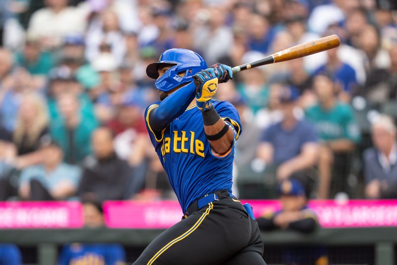 Jun 28, 2024; Seattle, Washington, USA; Seattle Mariners centerfielder Julio Rodriguez (44) hits a single during the first inning against the Minnesota Twins at T-Mobile Park. Mandatory Credit: Stephen Brashear-USA TODAY Sports