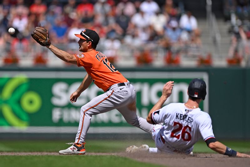 Jul 8, 2023; Minneapolis, Minnesota, USA;  Baltimore Orioles infielder Adam Frazier (12) catches a ball to force out Minnesota Twins outfielder Max Kepler (26) during the eighth inning at Target Field. Mandatory Credit: Nick Wosika-USA TODAY Sports