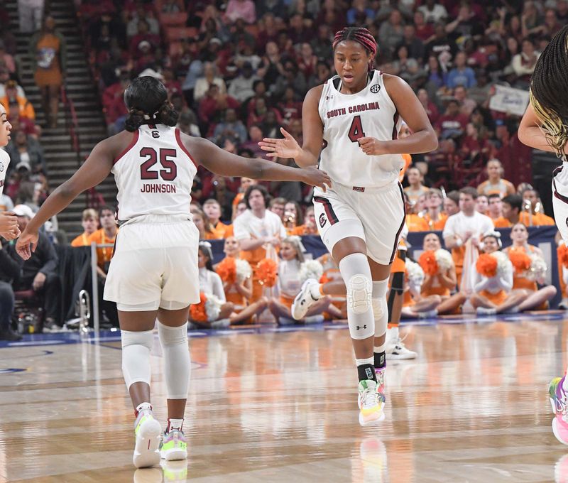Mar 5, 2023; Greenville, SC, USA; South Carolina forward Aliyah Boston (4) celebrates scoring with guard Raven Johnson (25) against Tennessee during the first quarter of the SEC Women's Basketball Tournament at Bon Secours Wellness Arena. Mandatory Credit: Ken Ruinard-USA TODAY Sports