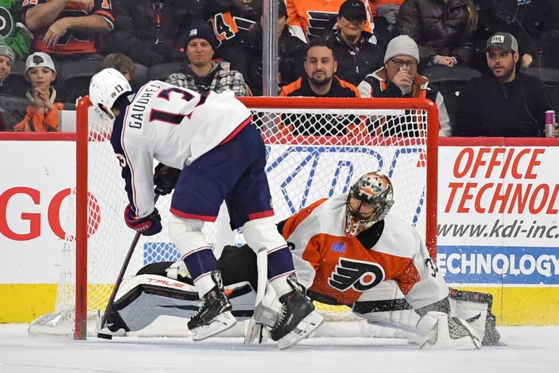 Jan 4, 2024; Philadelphia, Pennsylvania, USA; Columbus Blue Jackets left wing Johnny Gaudreau (13) scores a goal against Philadelphia Flyers goaltender Samuel Ersson (33) during the shootout at Wells Fargo Center. Mandatory Credit: Eric Hartline-USA TODAY Sports