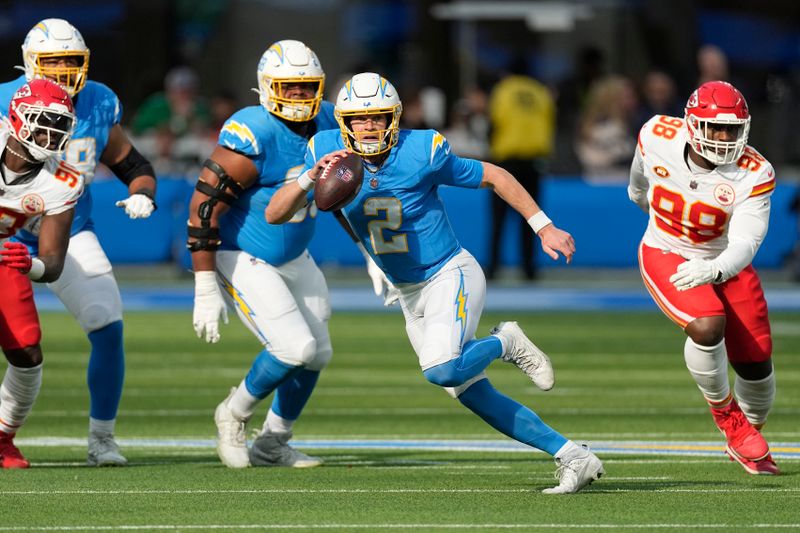 Los Angeles Chargers quarterback Easton Stick, right, scrambles away from Kansas City Chiefs defensive tackle Tershawn Wharton during the first half of an NFL football game, Sunday, Jan. 7, 2024, in Inglewood, Calif. (AP Photo/Mark J. Terrill)