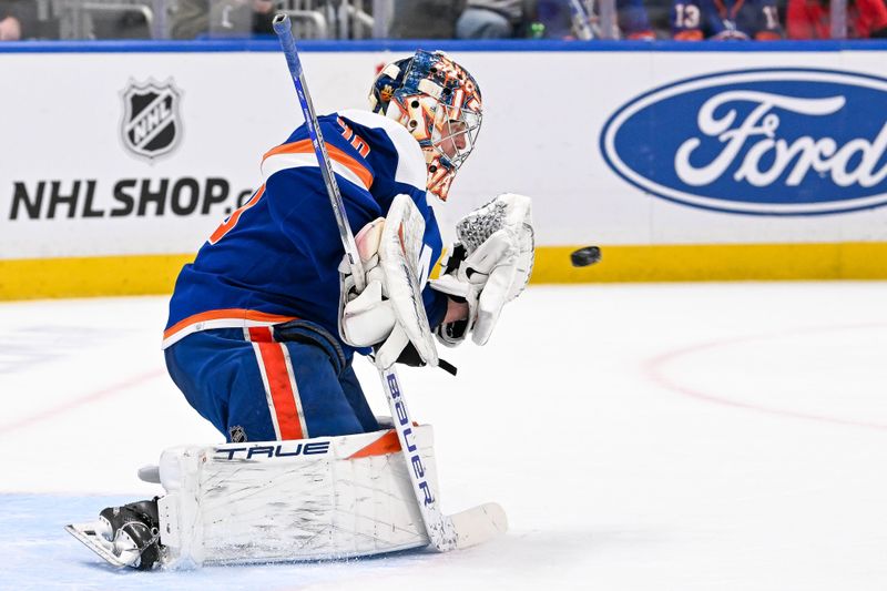 Jan 27, 2024; Elmont, New York, USA; New York Islanders goaltender Semyon Varlamov (40) makes a glove save against the Florida Panthers during the first period at UBS Arena. Mandatory Credit: Dennis Schneidler-USA TODAY Sports