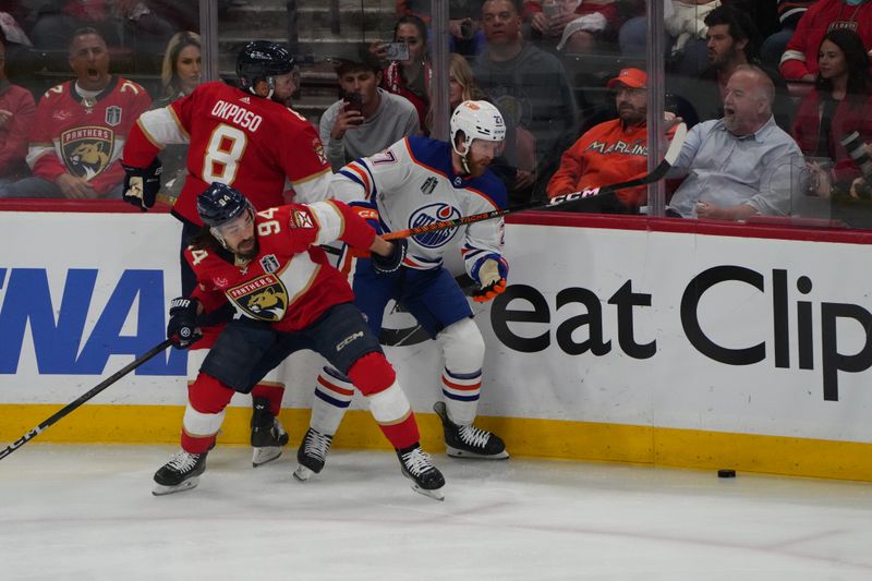 Jun 24, 2024; Sunrise, Florida, USA; Edmonton Oilers defenseman Brett Kulak (27) plays the puck against Florida Panthers forward Ryan Lomberg (94) during the first period in game seven of the 2024 Stanley Cup Final at Amerant Bank Arena. Mandatory Credit: Jim Rassol-USA TODAY Sports