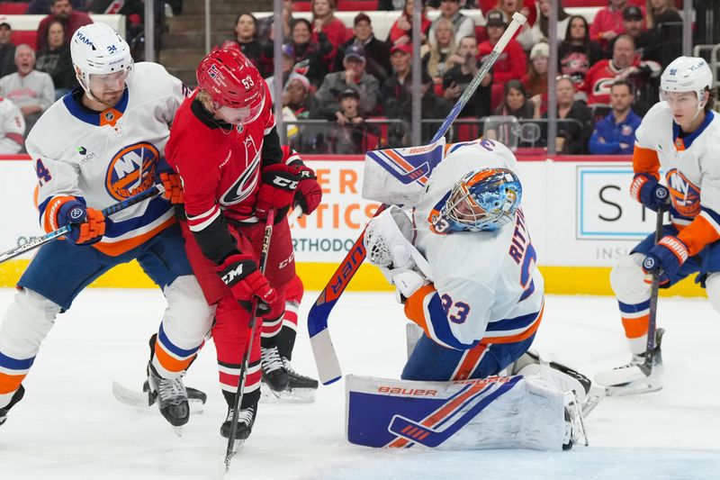 Oct 30, 2025; Raleigh, North Carolina, USA;  New York Islanders goaltender David Rittich (33) reacts to getting run into0 by Carolina Hurricanes right wing Jackson Blake (53) during the first period at Lenovo Center. Mandatory Credit: James Guillory-Imagn Images